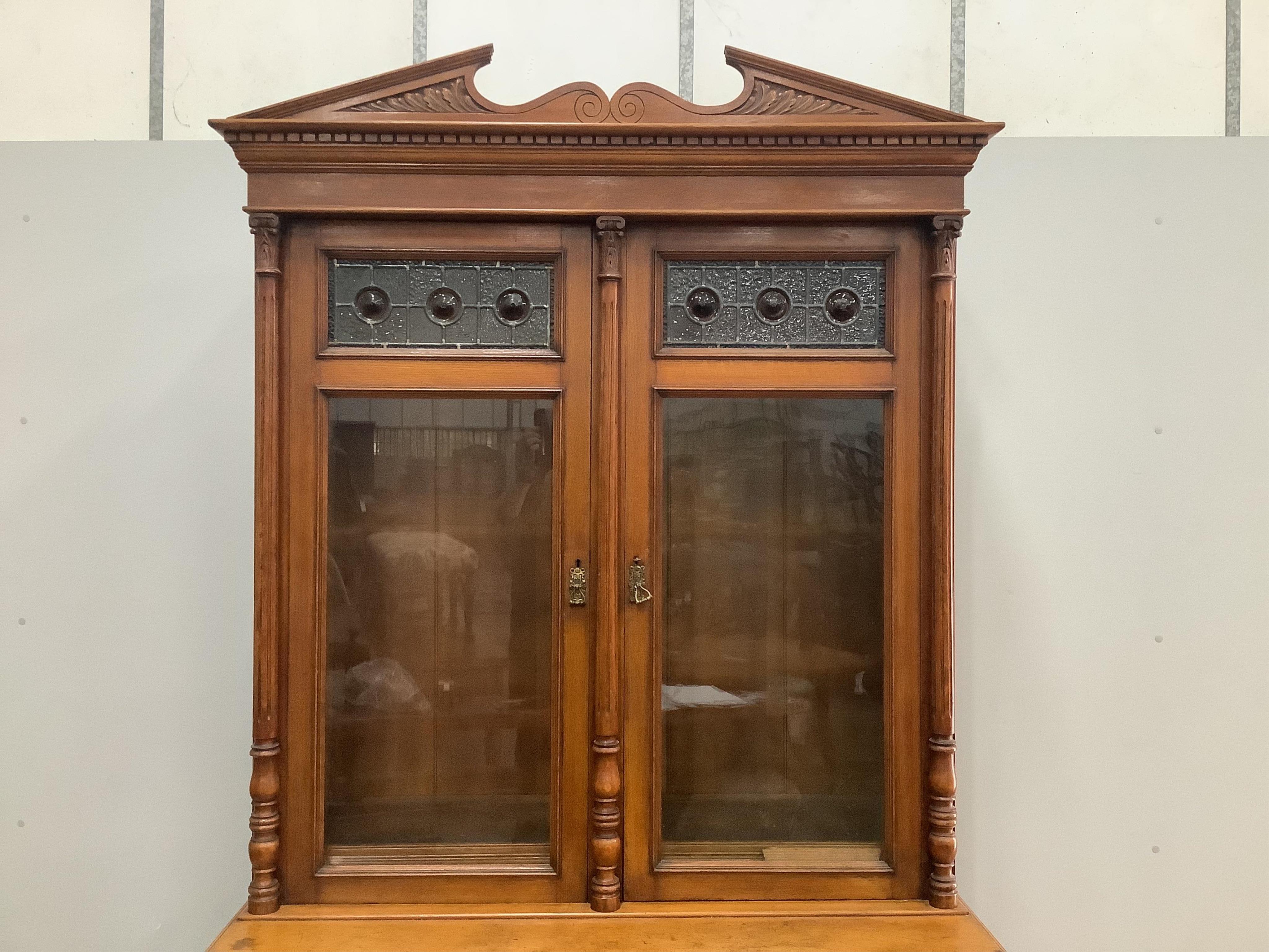 A late Victorian golden oak bookcase, width 123cm, height 238cm. Condition - fair